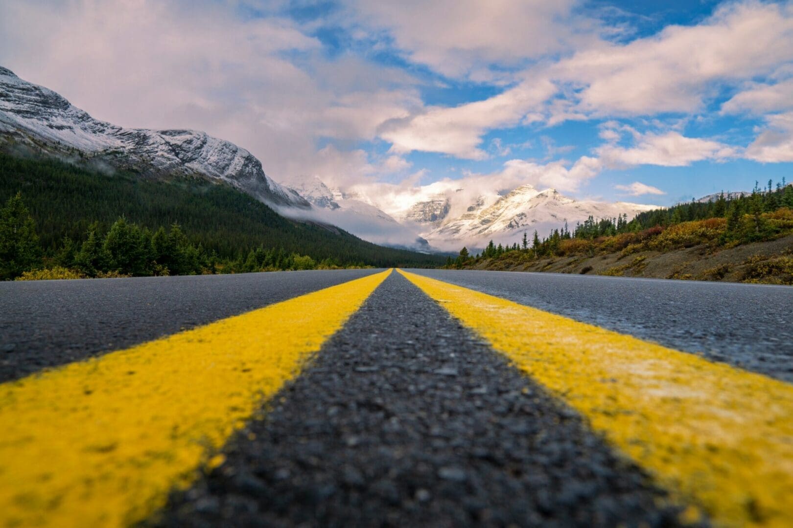 Open road leading toward snow-covered mountains, symbolizing healing and forward movement through emotion-focused therapy in Washington.